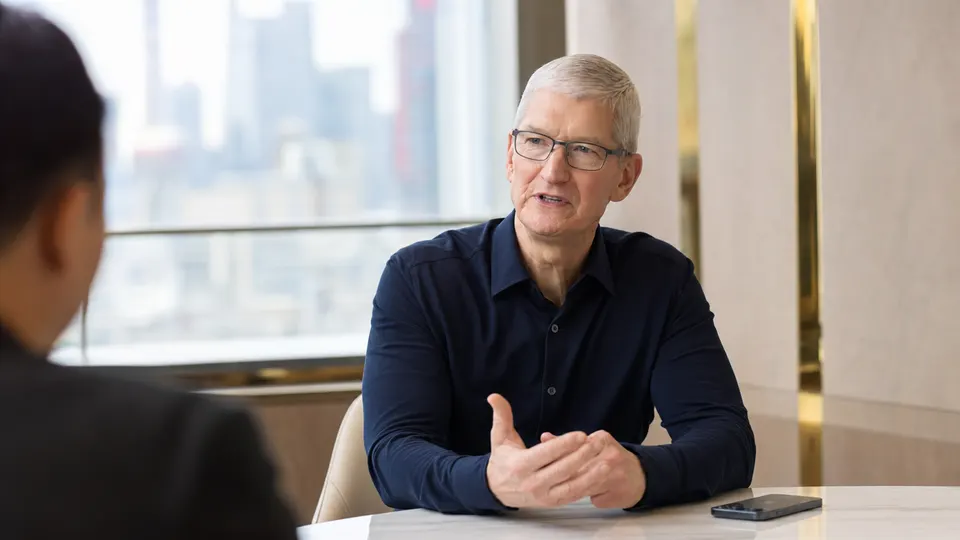 Illustrative photo of Tim Cook, Apple's executive chairman, in a Shanghai interview room with an iPhone on the table, speaking to someone off camera.