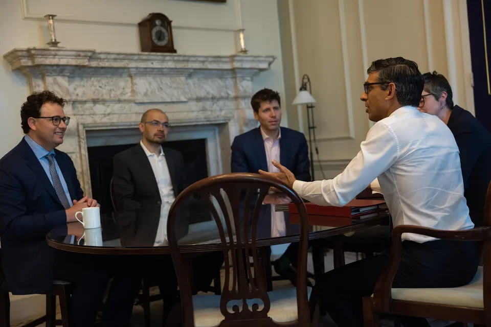 Dario Amodei sits at a round table in 10 Downing Street, smiling, with Demis Hassabis, Sam Altman and Prime Minister Rishi Sunak